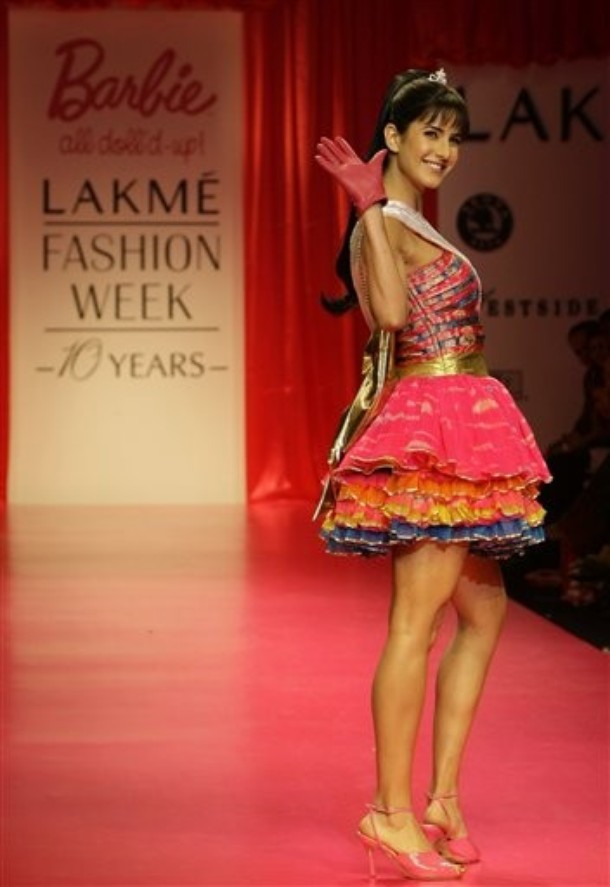 Bollywood actor Katrina Kaif, wearing a creation by Nishka Lula, gestures as she walks the ramp during a show to commemorate 50 years of Barbie doll